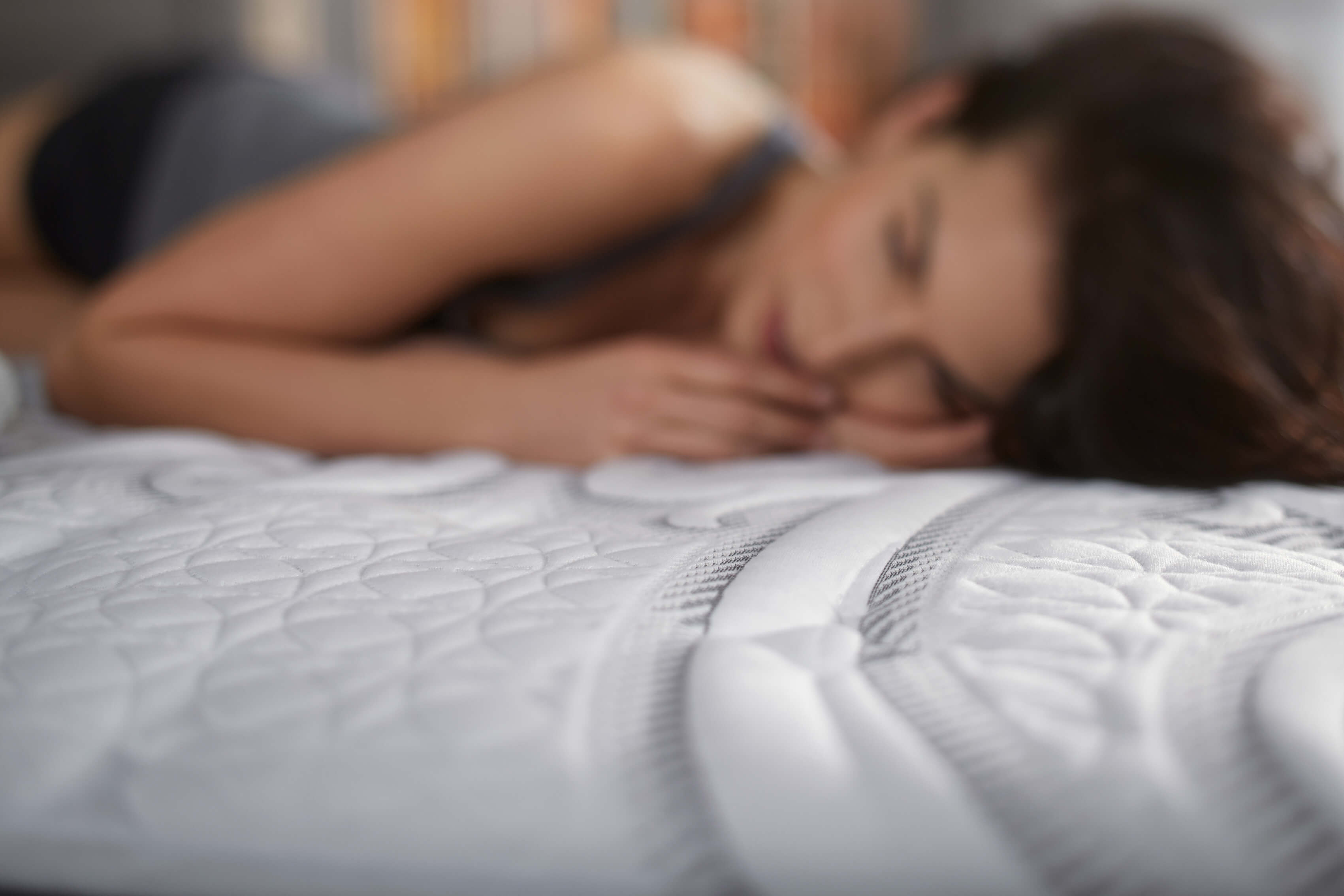 Woman laying on mattress